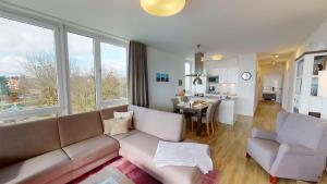 a living room with a couch and a dining room at Südkap E-04 in Pelzerhaken