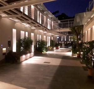 a building with a lit up courtyard at night at Ciclope Resort in Acitrezza