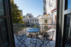 a table and chairs sitting on a balcony at Ederlezi Zoubourlou Aparthotel in Athens
