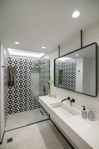 a bathroom with a sink and a mirror at Ederlezi Zoubourlou Aparthotel in Athens