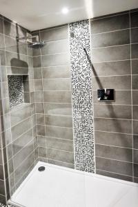 a bathroom with a shower stall and a toilet at BEST WESTERN Brook Hotel in Norwich