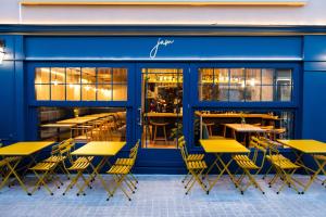 a group of tables and chairs outside of a restaurant at Old Port Hotel in Limassol