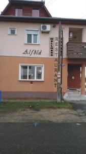 a building with a sign on the side of it at Alföld Panzio & Étterem in Cegléd