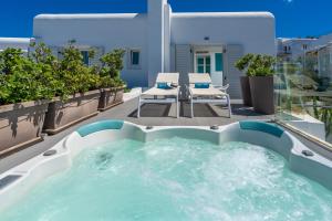 a hot tub on the balcony of a house at Semeli Hotel Mykonos in Mikonos