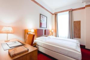 Łóżko lub łóżka w pokoju w obiekcie Hotel Allegro Wien