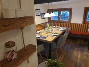 a dining room with a wooden table and chairs at Bergführerhaus in Ramsau am Dachstein