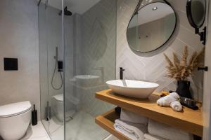 a bathroom with a sink and a mirror at Old Port Hotel in Limassol