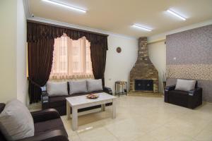 a living room with a couch and a fireplace at Tatev Hotel and Tours in Yerevan