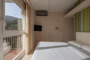 Ένα ή περισσότερα κρεβάτια σε δωμάτιο στο Casa Vacanze Olivo - Portovenere - 5 steps to the water