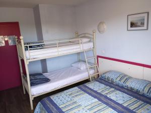 a bedroom with two bunk beds and a bed at Hôtel Triotel in La Valette-du-Var