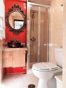 a bathroom with a toilet and a sink and a mirror at Casa da Avó in Elvas +32 photos