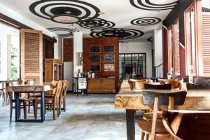a restaurant with tables and chairs in a room at Exotic Chamber in Malang