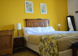 En eller flere senge i et værelse på Estancia del Olivo
