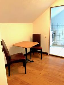 a table and two chairs in a room at City Apartments in Osterholz-Scharmbeck +1 photo