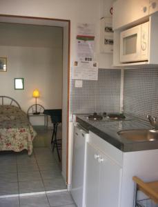 a kitchen with a sink and a room with a bed at Chambres d'hotes Welcome Trépied in Cucq +34 photos