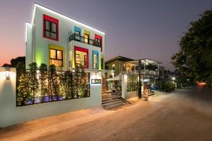 a white building with colorful windows on a street at Viryla Boutique Hotel in Vientiane