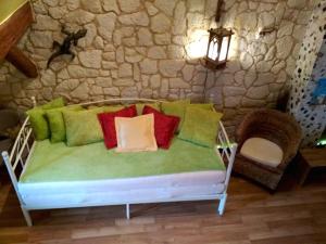 a bench with colorful pillows on it in a room at Grüne Franziska in Ettenheim