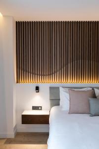 a bedroom with a bed and a large window at Old Port Hotel in Limassol