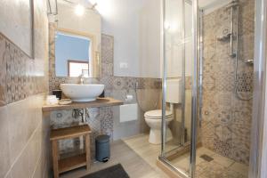a bathroom with a toilet and a sink and a shower at Salento Inside in Morciano di Leuca +47 photos
