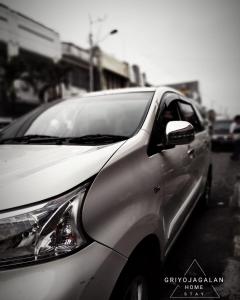 a silver car parked on the side of a street at Griyo Jagalan in Borobudur