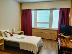 Postel nebo postele na pokoji v ubytování Hotelli Kaatrahovi
