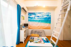 a bedroom with a bunk bed with a desk and a ladder at レベアス片瀬江ノ島WEST in Katase