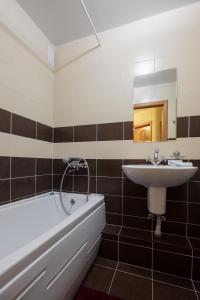 a bathroom with a sink and a bath tub and a sink at OK! Советская, 69 №1 in Tomsk