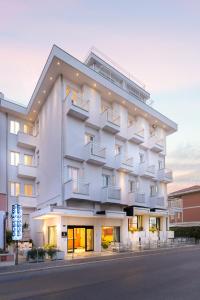 a large white building on the side of a street at Hotel Mirabel in Rimini