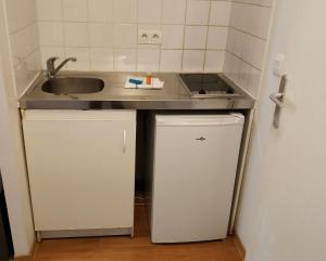 a small kitchen with a sink and a refrigerator at City Résidence Marseille in Marseille