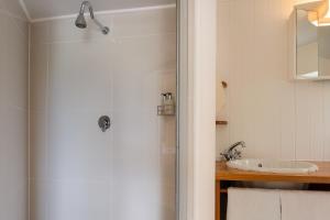 a bathroom with a shower and a sink at Lagoon - Cottage in Wilderness +31 photos