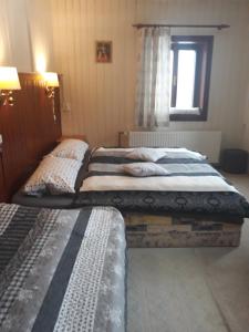 Posteľ alebo postele v izbe v ubytovaní Guest House Leona