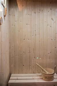 a room with a wooden wall with a bucket in it at Wellness Home Crisalide SPA in Fasano