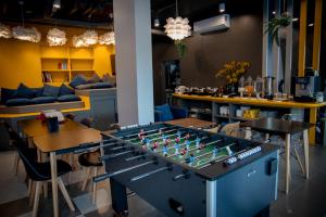 a foosball table in the middle of a room at Sleep Mai Chiang Mai Airport Lifestyle Hotel in Chiang Mai +29 photos