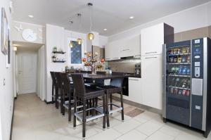 a kitchen with a table and chairs and a refrigerator at Bed & Breakfast Armonie Romane in Rome