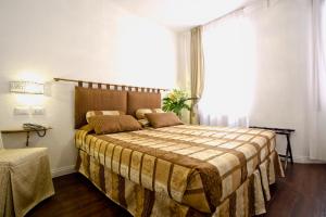 Cama ou camas em um quarto em Albergo Marin