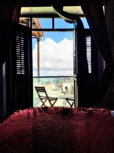 a room with a window with a chair and a view at La Terraza de San Juan in San Juan
