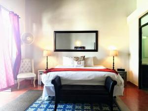 a hotel room with a bed, desk, and lamp at La Terraza de San Juan in San Juan