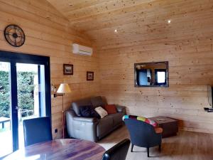 a living room with a couch and a table at La KJOTTE avec option jacuzzi in Le Teich
