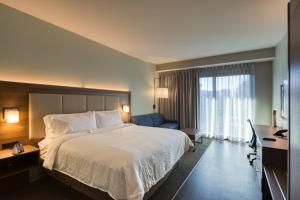 a hotel room with a large bed and a desk at Holiday Inn Express & Suites - Charlotte - South End, an IHG Hotel in Charlotte