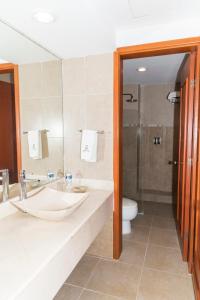 a bathroom with a sink and a toilet and a shower at Hotel Gran Via - Centro in Veracruz