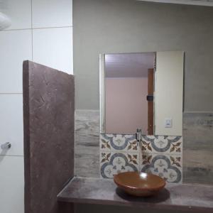 a bathroom with a wooden sink and a mirror at Pousada Raposa in Ibicoara