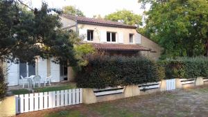 a white fence in front of a house at Appartement SOULAC SUR MER À 500 m de la plage N 4 in Soulac-sur-Mer