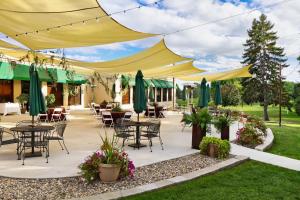 a patio with tables and chairs and umbrellas at Lake Okoboji Resort and Conference Center in Okoboji