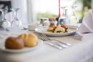 a table with a plate of food and wine glasses at Bizerta Resort Congres & SPA in Bizerte