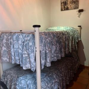 a bed in a room with a bedspread on it at Casa Cuco in Serdio