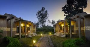 an exterior view of a building at night at Aranyak Resort in Tāla