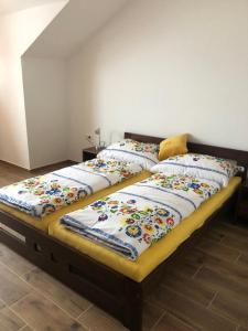 two beds with pillows on them in a room at Ubytovanie Včelárstvo Greško in Liptovský Mikuláš