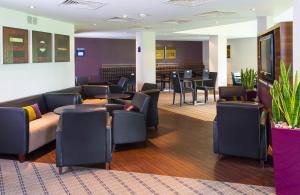 a living room filled with furniture and a large window at Holiday Inn Express Stirling, an IHG Hotel in Stirling