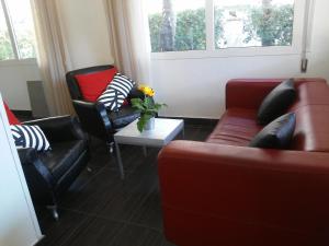 a living room with two couches and a table at Fasthotel in Cervia
