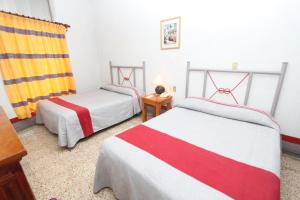 Hotel Posada el Cid tesisinde bir odada yatak veya yataklar